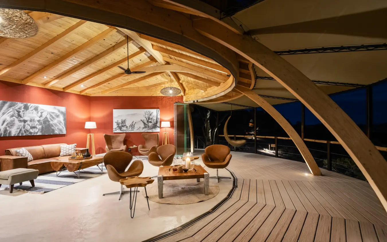 Modern lounge with wooden ceiling beams and open deck, Onduli Ridge, Damaraland, Namibia