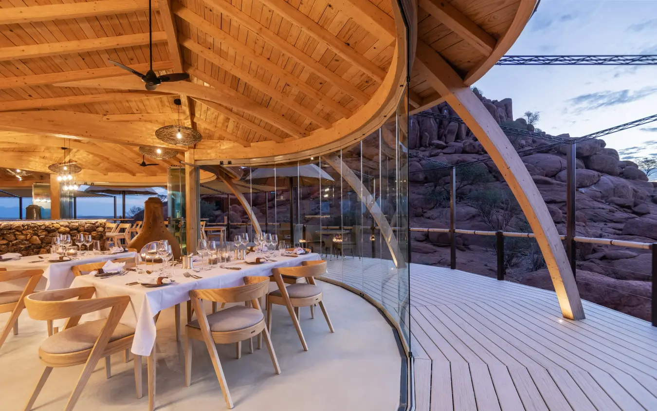 Dining area with wooden architecture and rocky landscape views, Onduli Ridge, Damaraland, Namibia