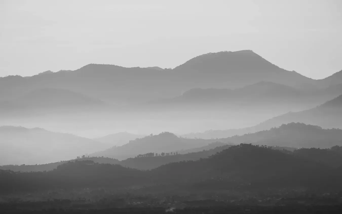 Layered mountain ranges with morning mist and forest coverage, Gorilla’s Nest, Volcanoes National Park, Rwanda