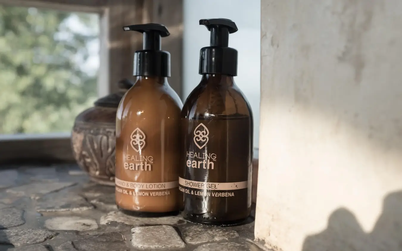 Luxury toiletries displayed on stone windowsill with savanna view, Ongava Lodge, Etosha National Park, Namibia