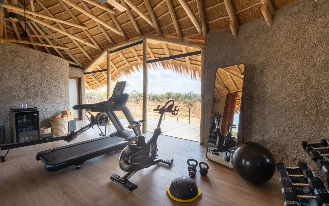 Fitness studio with exercise equipment overlooking savanna landscape, Onguma Camp Kala, Etosha National Park, Namibia