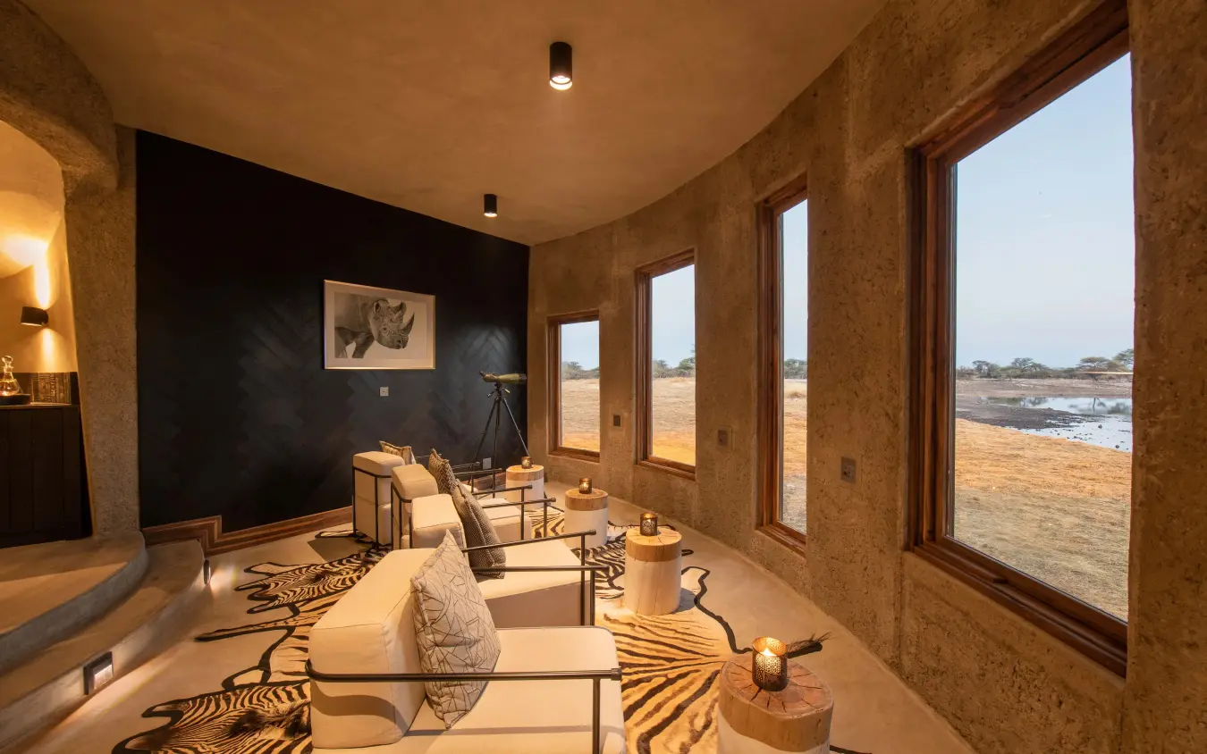 Spa treatment room with views over arid landscape and waterhole, Onguma Camp Kala, Etosha National Park, Namibia