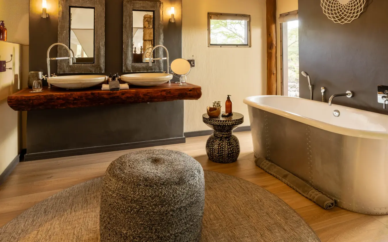 Luxury bathroom with dual vanity, freestanding tub and natural wood finishes, Onguma Tented Camp, Etosha National Park, Namibia