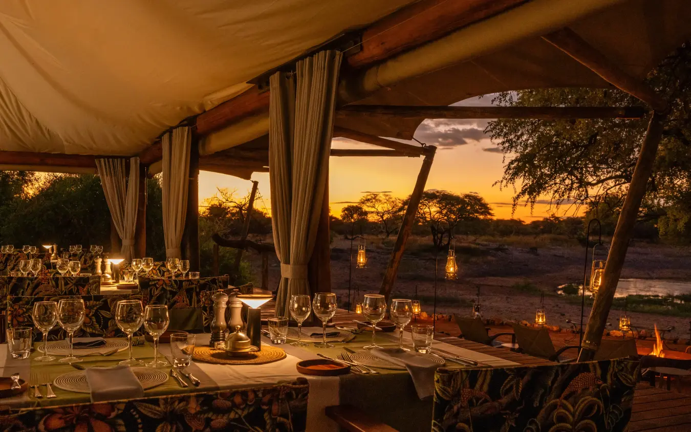 Outdoor dining pavilion at sunset overlooking savanna landscape, Onguma Tented Camp, Etosha National Park, Namibia