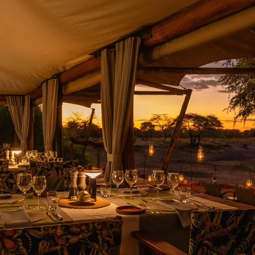 Outdoor dining pavilion at sunset overlooking savanna landscape, Onguma Tented Camp, Etosha National Park, Namibia