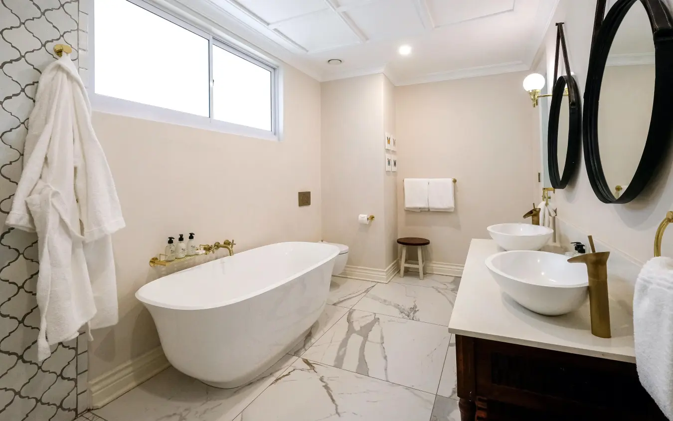 Modern bathroom with freestanding tub and dual vanities, Palm River Hotel, Victoria Falls, Zimbabwe