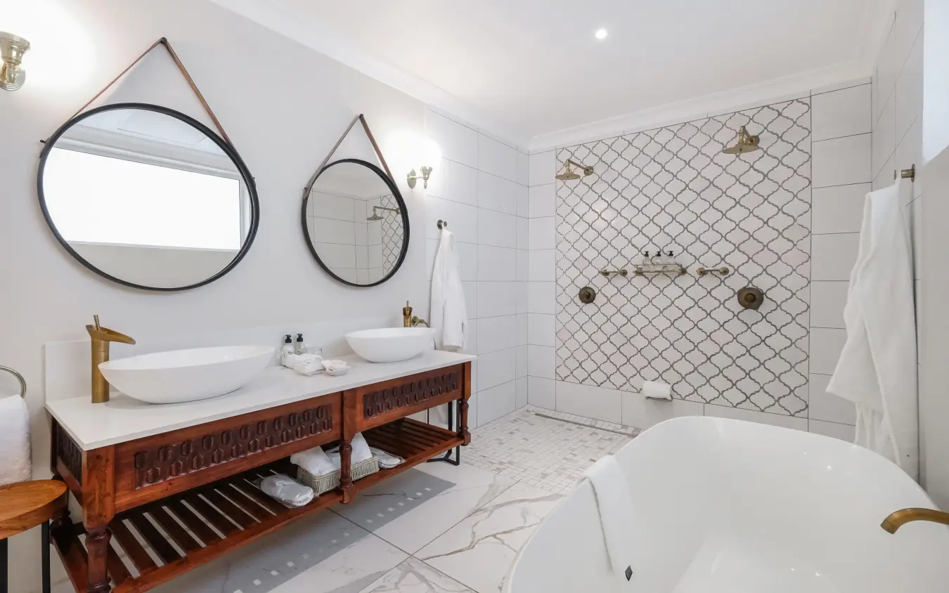Modern bathroom with dual vessel sinks and freestanding tub, Palm River Hotel, Victoria Falls, Zimbabwe