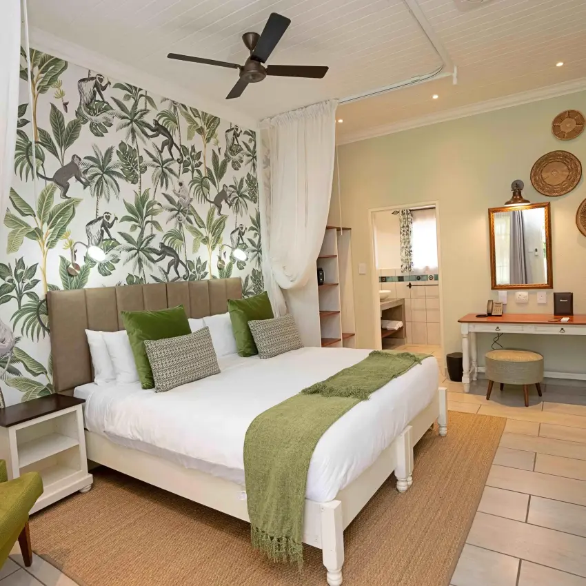 Bright bedroom with botanical wallpaper and green accents, Pioneers Lodge, Victoria Falls, Zimbabwe