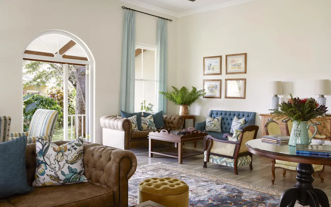 Elegant sitting room with leather seating and arched windows, Pioneers Lodge, Victoria Falls, Zimbabwe