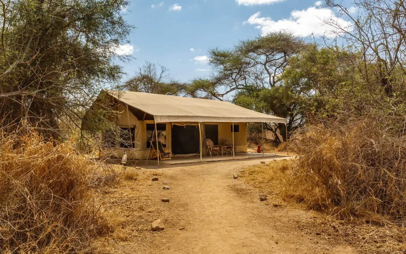 Safari camp canvas tent with extended awning in semi-arid bushland, Porini Amboseli Camp, Amboseli and Chyulu Hills, Kenya