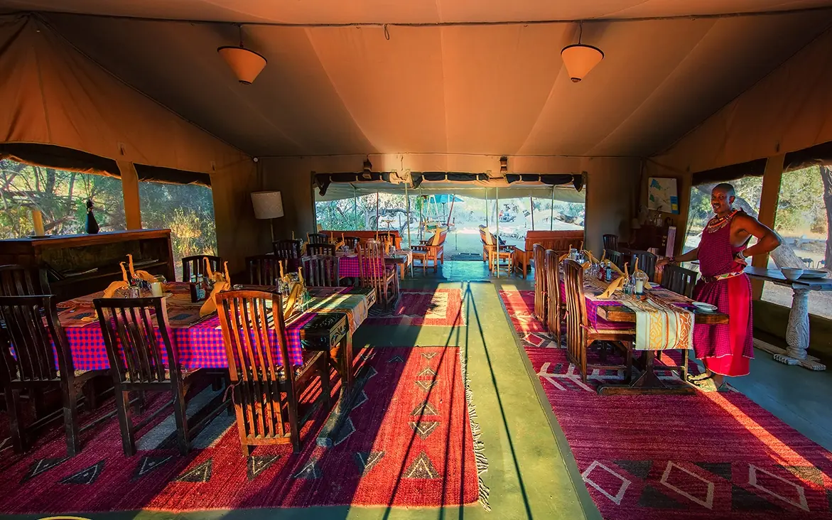 Luxury safari lodge interior with colorful rugs and waterfront views, Porini Amboseli Camp, Amboseli and Chyulu Hills, Kenya