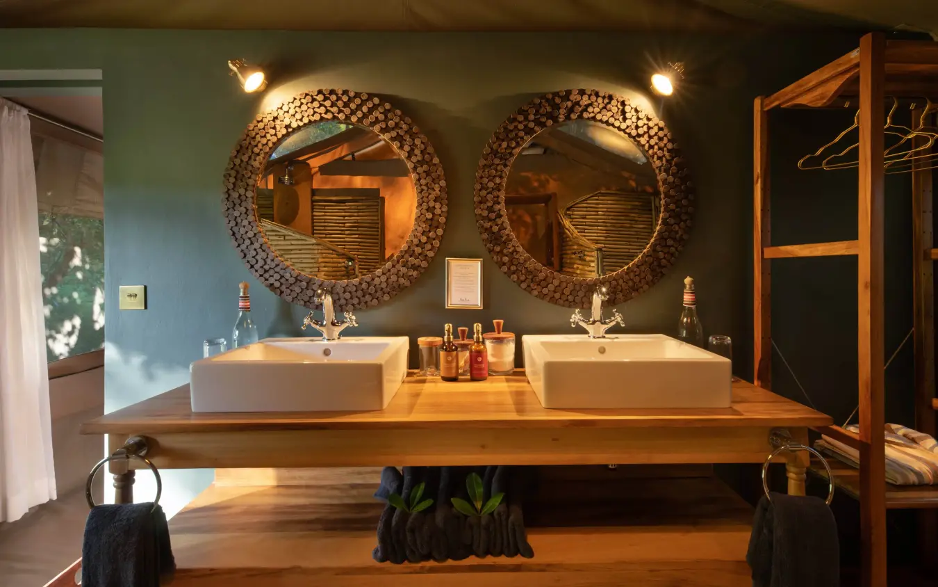 Dual vessel sinks with decorative mirrors and wooden vanity, Rekero Camp, Maasai Mara, Kenya