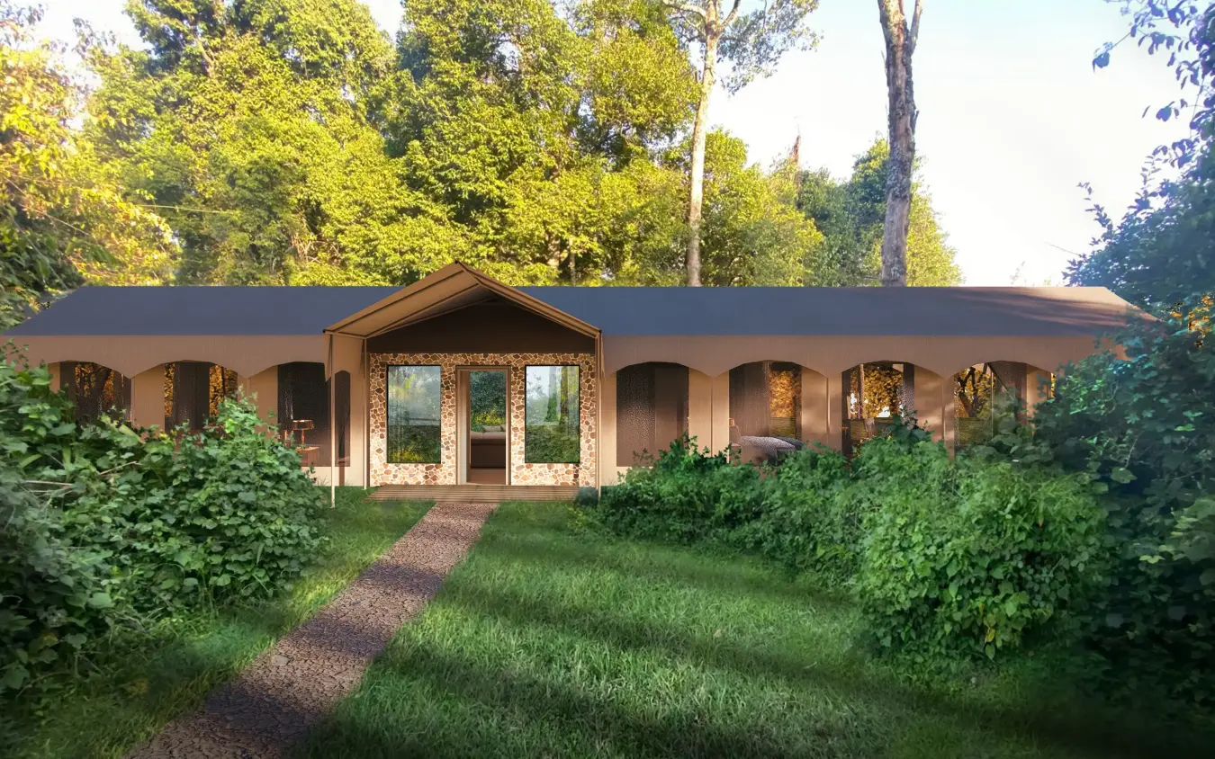 Curved tan structure with large windows surrounded by green vegetation, Rekero Camp, Maasai Mara, Kenya
