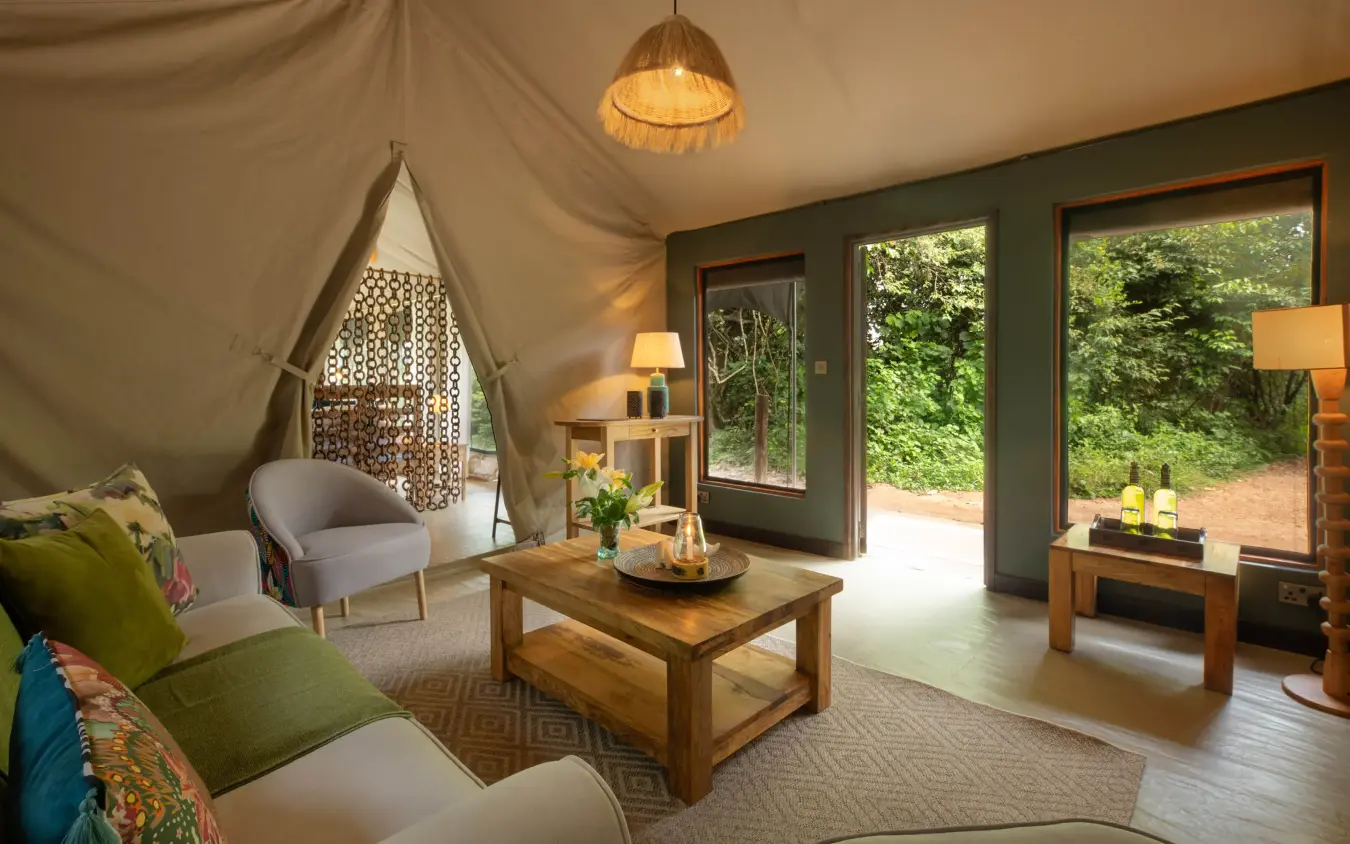 Luxury safari tent bedroom with canvas canopy and forest views, Rekero Camp, Maasai Mara, Kenya