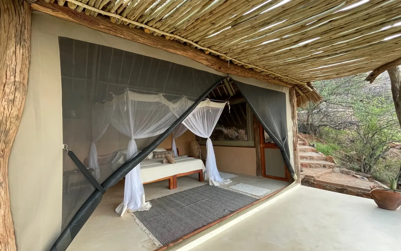 Open-air bedroom pavilion with draped four-poster bed, Reteti House, Northern Kenya, Kenya