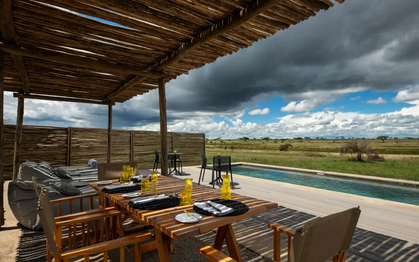 Wooden deck overlooking savanna landscape with pool, The Retreats at Namiri Plains, Serengeti National Park, Tanzania