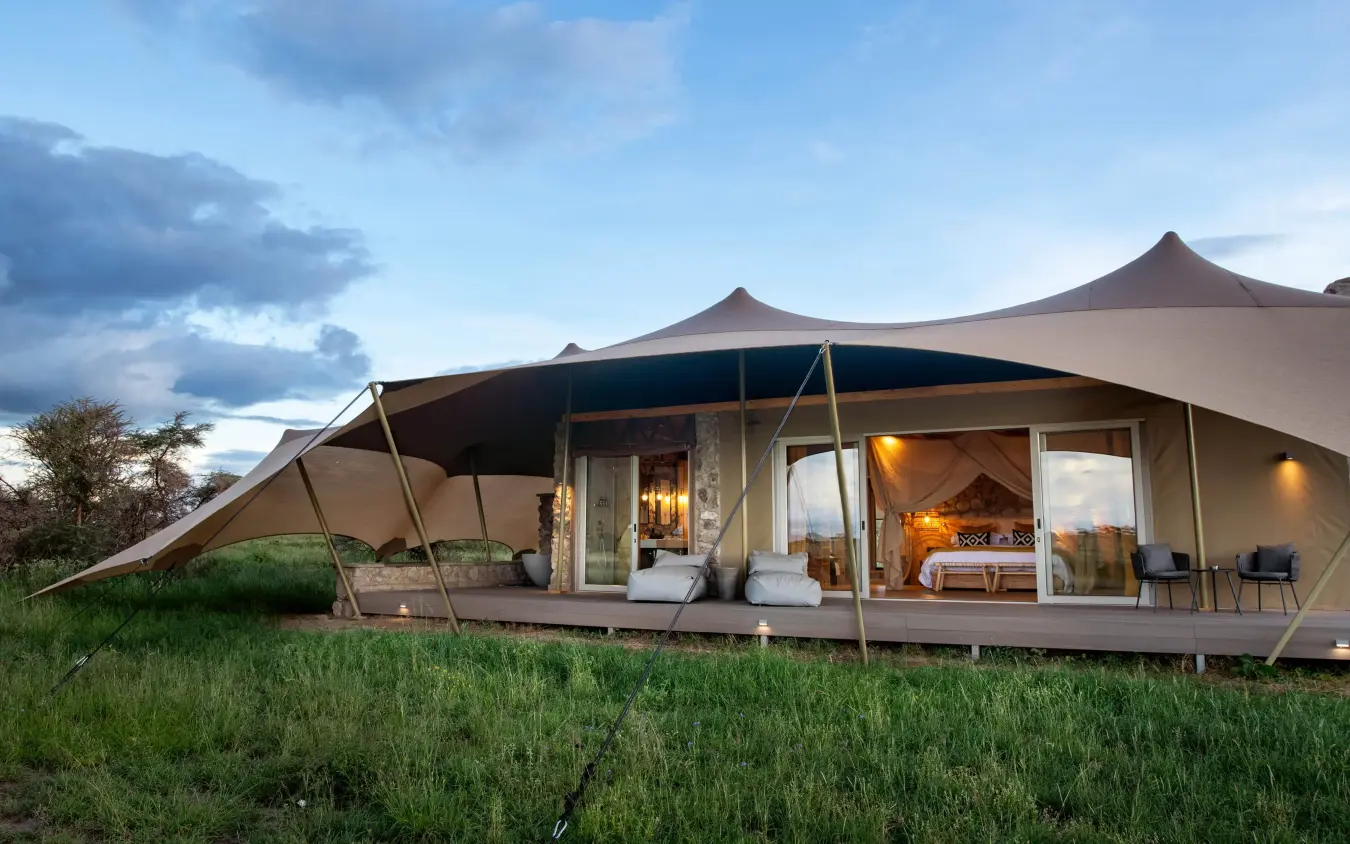 Canvas safari tent with wooden deck at dusk, The Retreats at Namiri Plains, Serengeti National Park, Tanzania