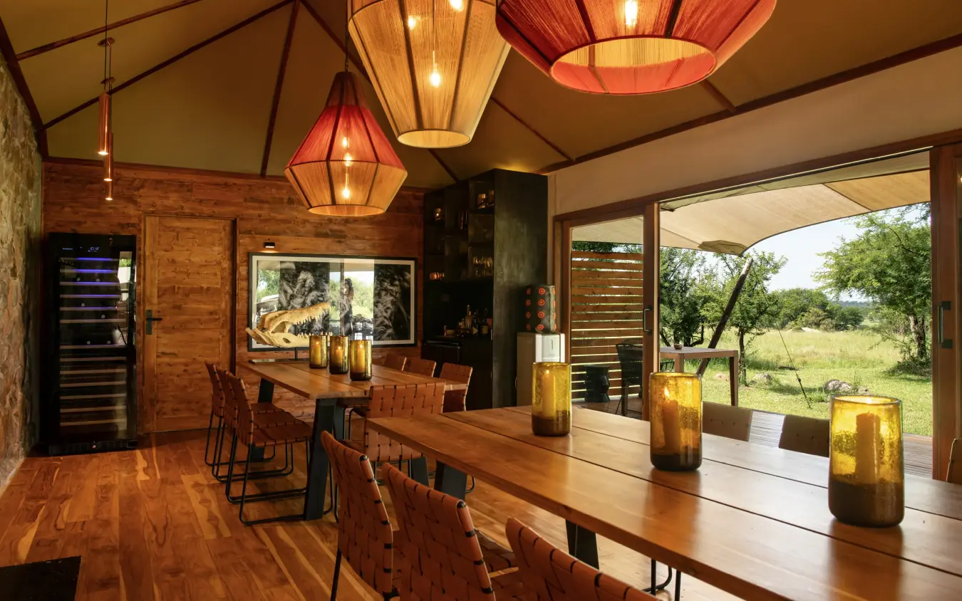 Open-air dining room with wooden tables and landscape views, The Retreats at Sayari Camp, Serengeti National Park, Tanzania