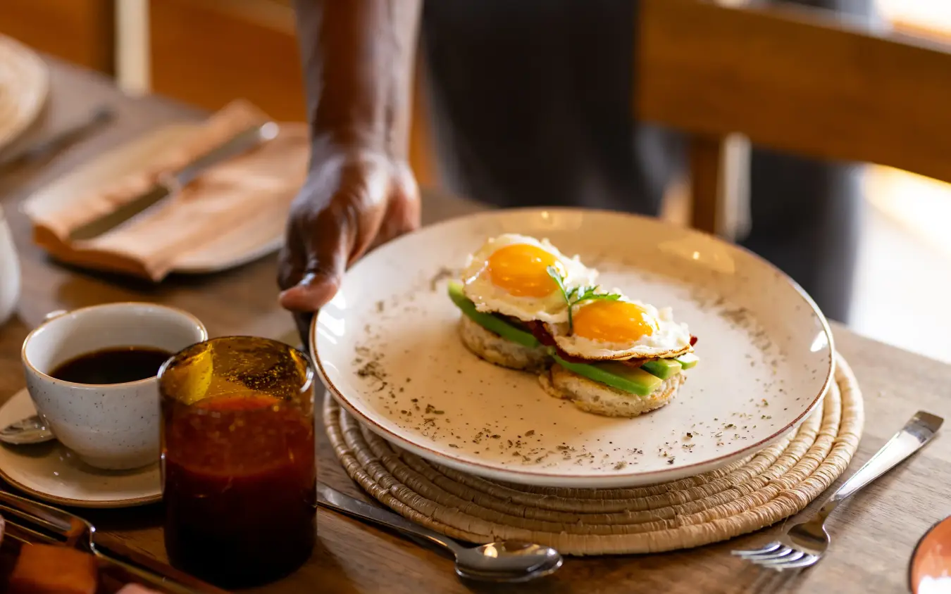 Plated breakfast with fried eggs and avocado toast, The Retreats at Sayari Camp, Serengeti National Park, Tanzania