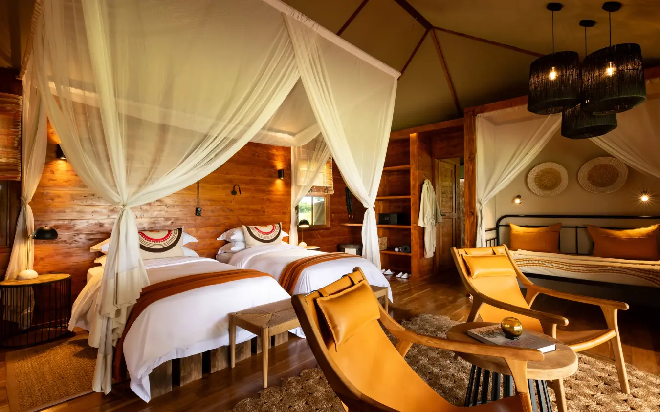 Luxury bedroom with canopy bed and wooden furnishings, The Retreats at Sayari Camp, Serengeti National Park, Tanzania