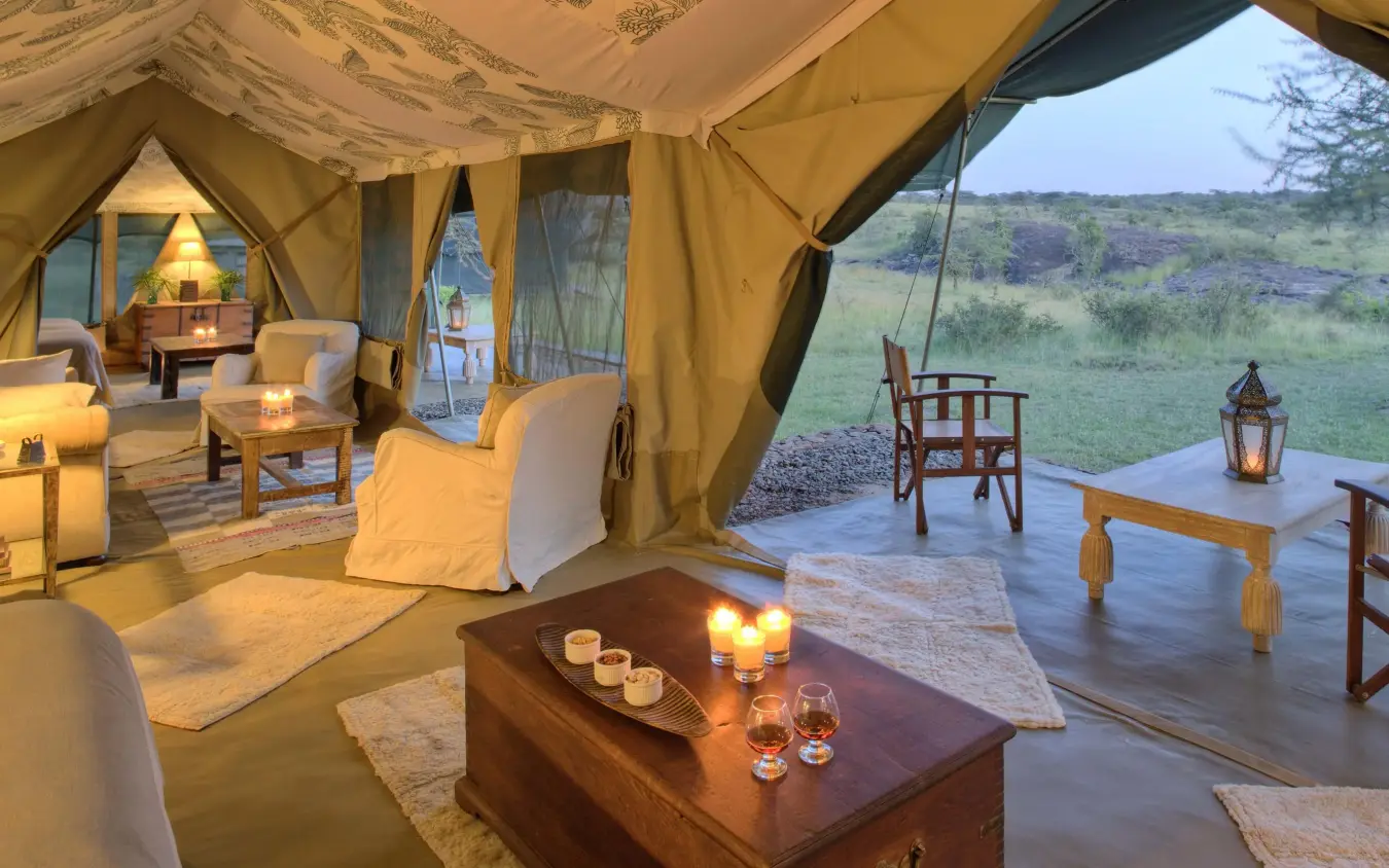 Luxury canvas tent with deck overlooking savanna landscape, Richard’s River Camp, Maasai Mara, Kenya