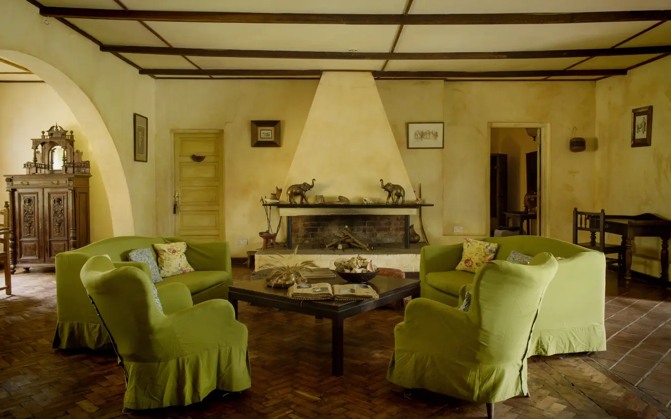 Spacious lounge with lime green seating and fireplace, Rivertrees Country Inn, Arusha, Tanzania