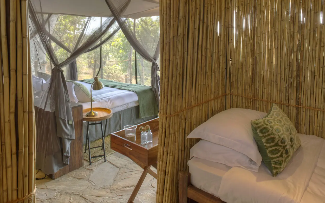 Luxury bedroom with four-poster bed and natural light, Roho ya Selous, Nyerere National Park, Tanzania