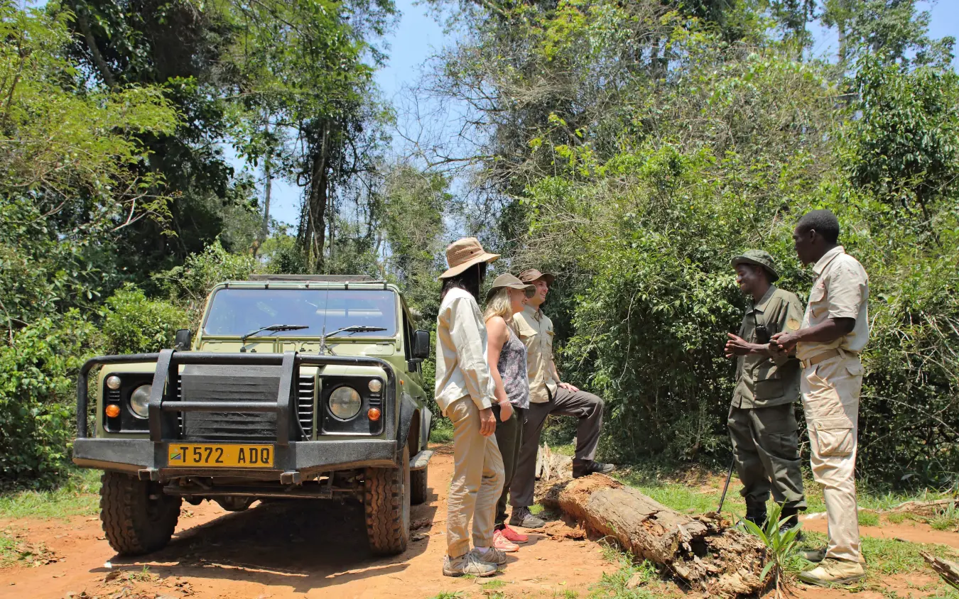 Guides briefing guests on safari vehicle during bush excursion, Rubondo Island Camp, Rubondo Island, Tanzania