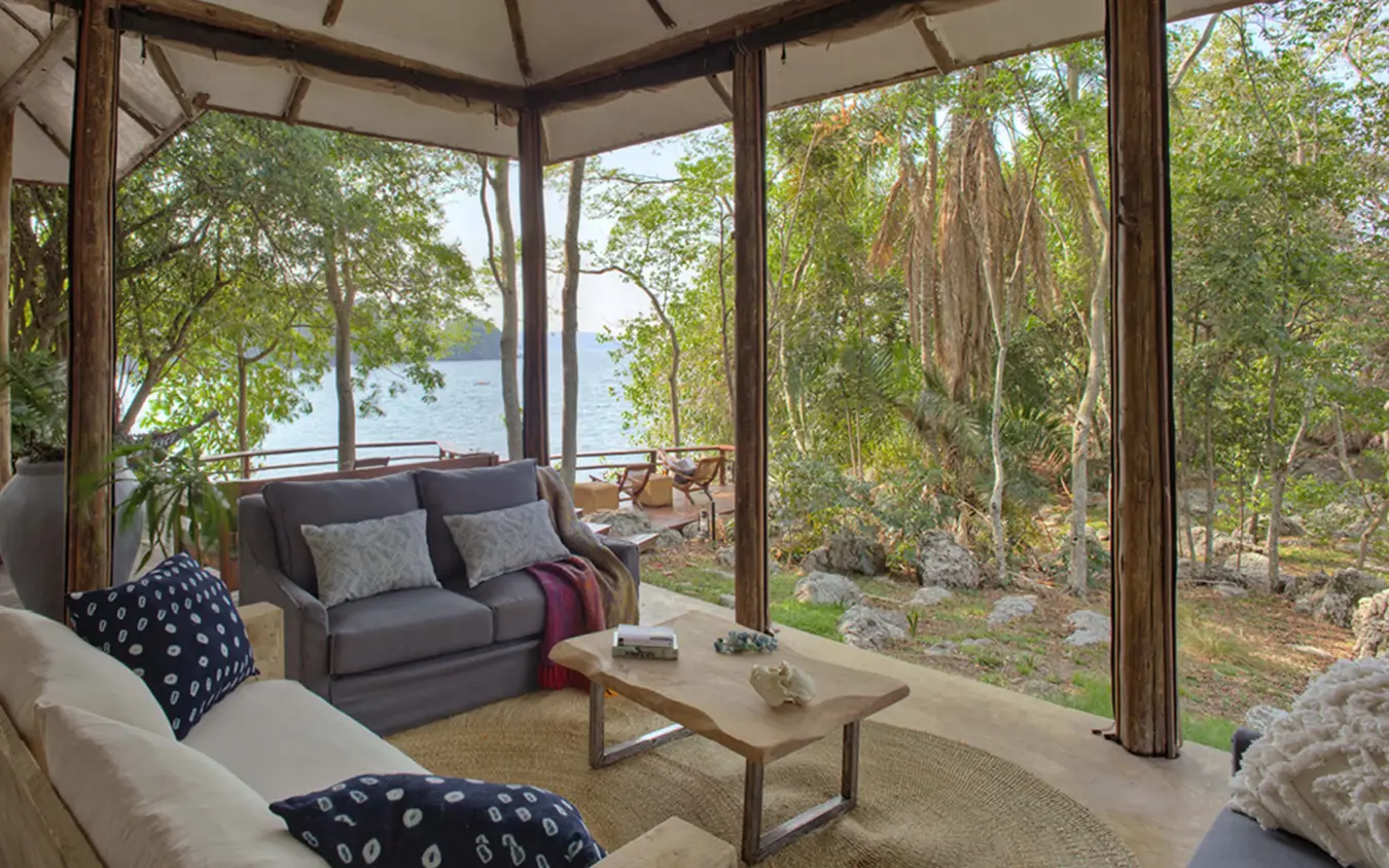 Lakeside lounge pavilion with comfortable seating and water views, Rubondo Island Camp, Rubondo Island, Tanzania