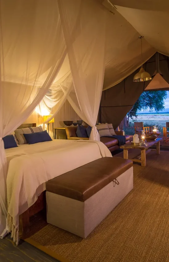 Luxury safari tent bedroom with river view at dusk, Ruckomechi Camp, Mana Pools, Zimbabwe