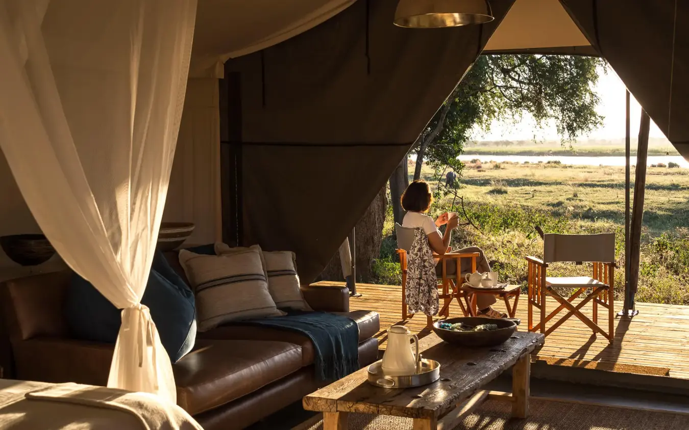 Safari lodge interior with river view and outdoor seating, Ruckomechi Camp, Mana Pools, Zimbabwe