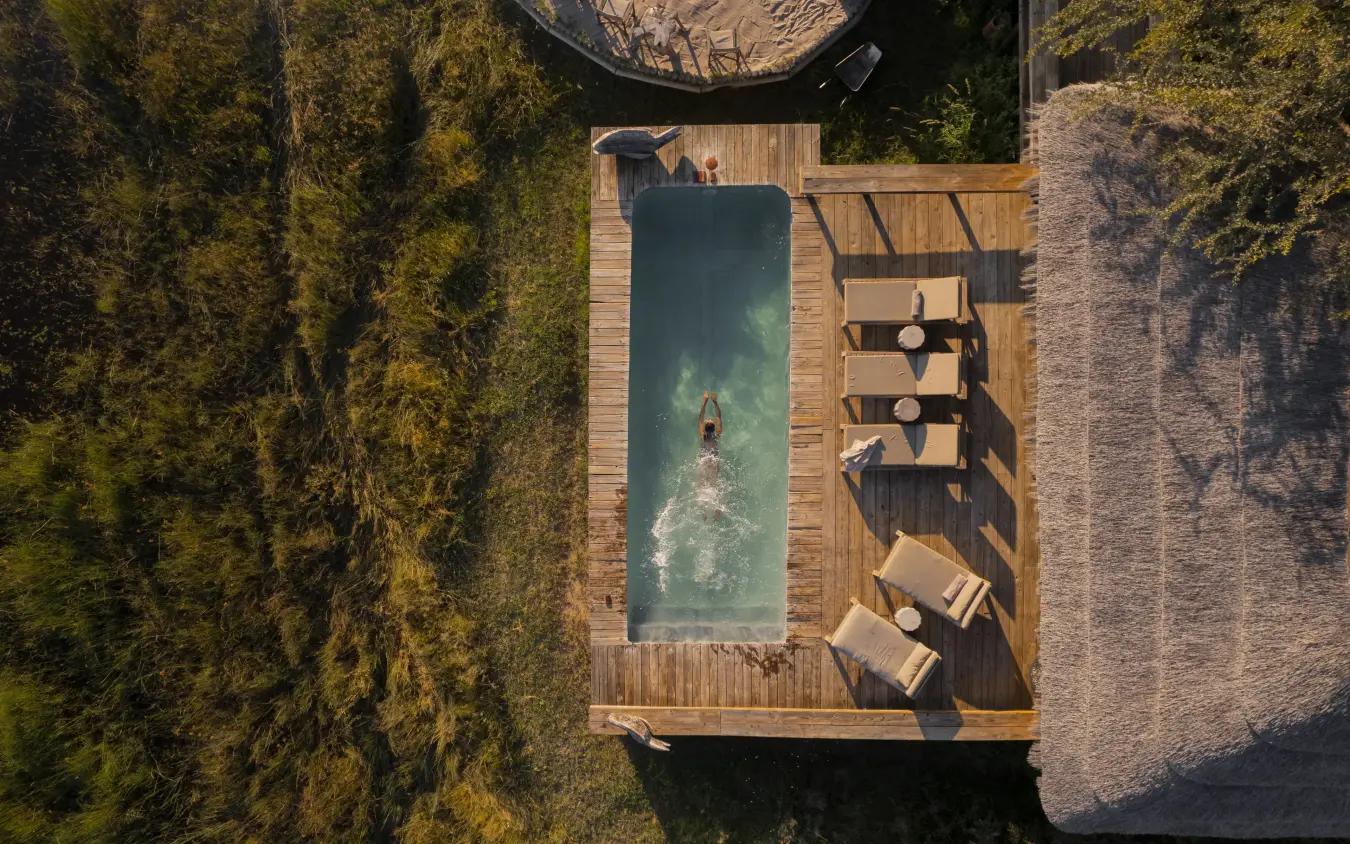 Aerial view of guest swimming in rectangular pool, Sable Alley, The Okavango Delta, Botswana