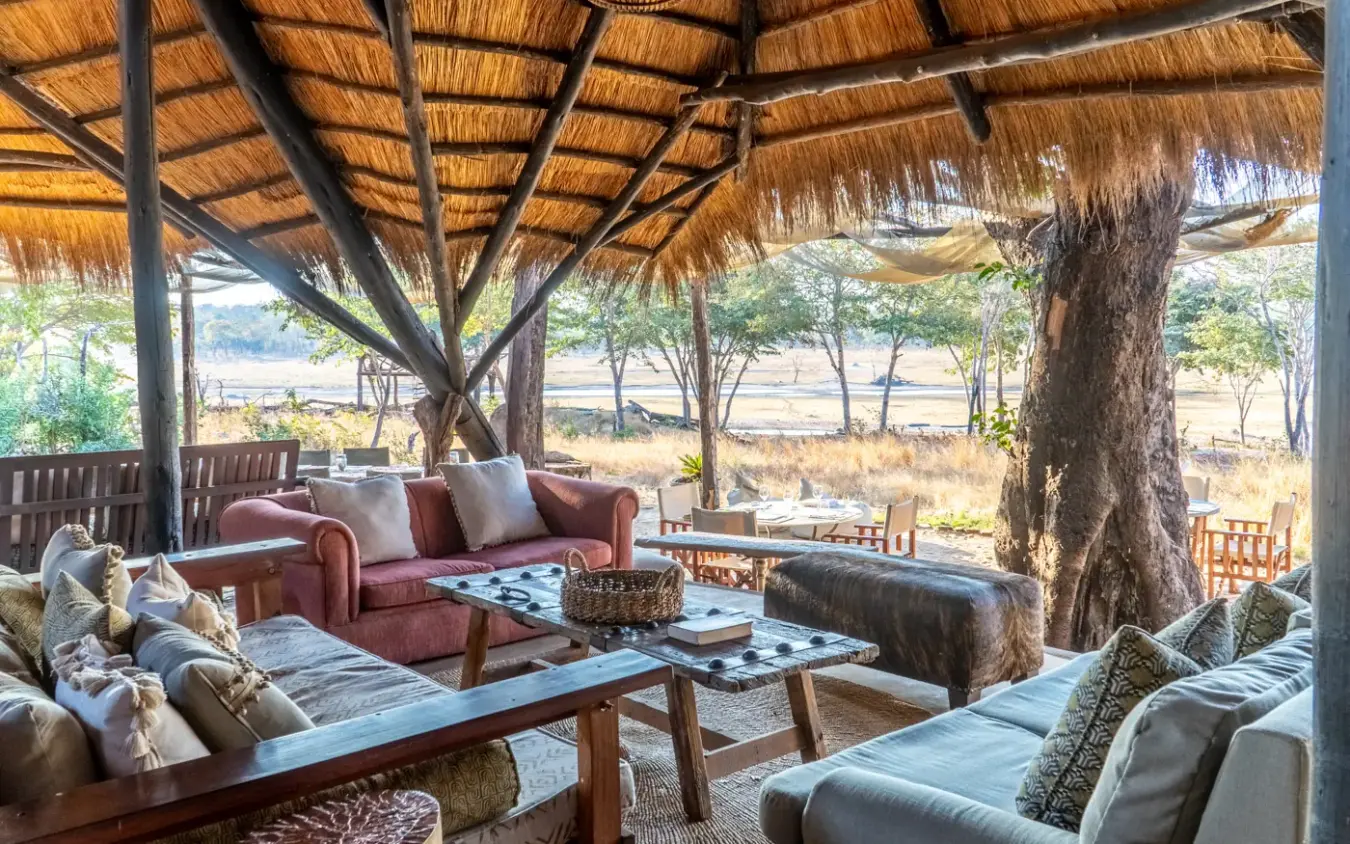 Open-air lounge with thatch roof overlooking savanna landscape, Sable Valley Lodge, Hwange National Park, Zimbabwe
