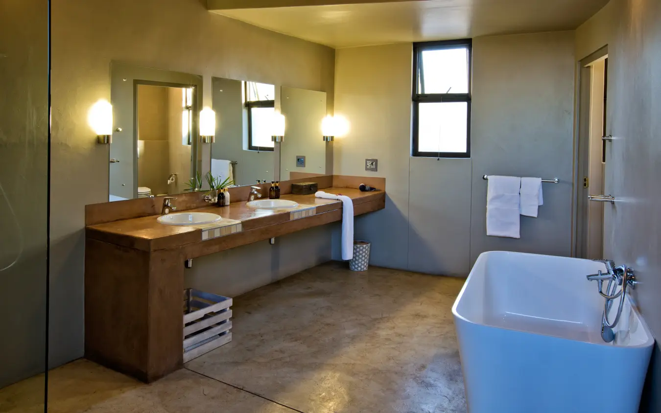 Luxury bathroom with wooden vanity and freestanding white bathtub, Safarihoek Lodge, Etosha National Park, Namibia