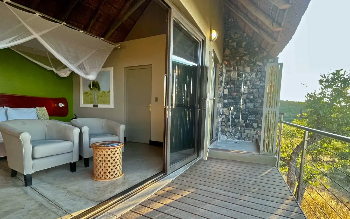 Luxury bedroom suite with open-air deck overlooking savanna landscape, Safarihoek Lodge, Etosha National Park, Namibia
