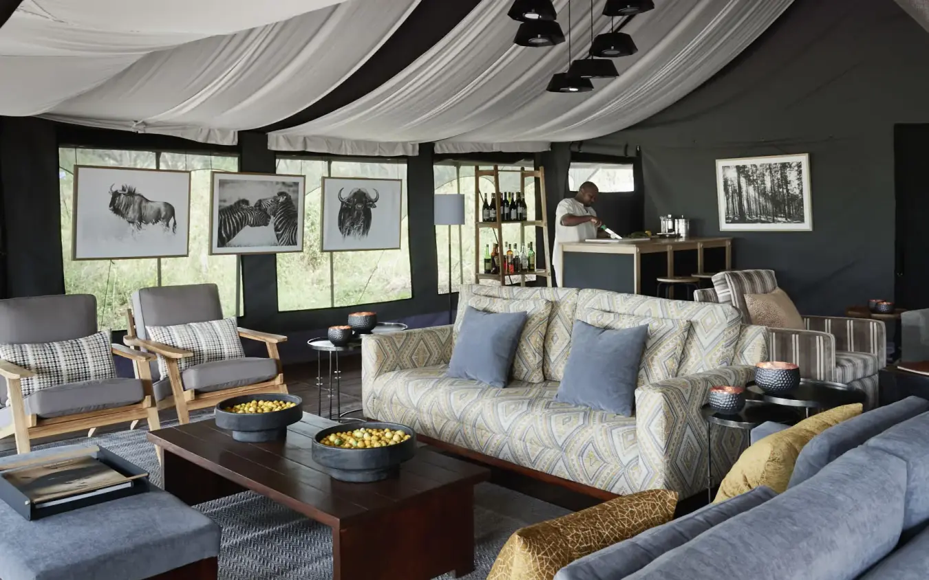 Luxurious safari lodge lounge with draped ceiling and wildlife artwork, Sanctuary Crater Camp, Ngorongoro Crater, Tanzania