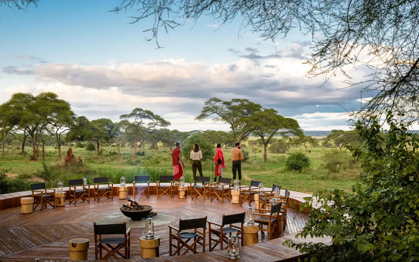 Outdoor dining deck with staff overlooking acacia woodland savanna, Swala, Tarangire National Park, Tanzania