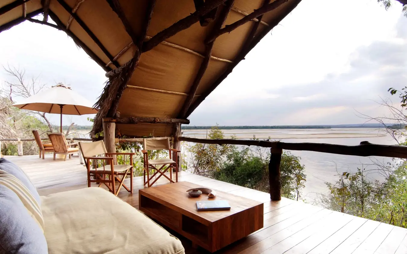Luxury safari lodge deck with river views and canvas canopy shelter, Sand Rivers, Nyerere National Park, Tanzania