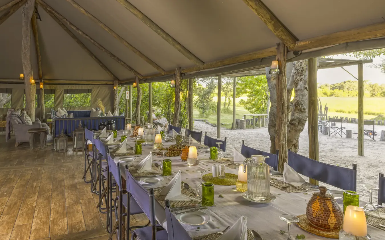 Elegant dining tent with tables set for dinner overlooking savanna landscape, Sango Expedition Camp, Gonarezhou & Malilangwe, Zimbabwe