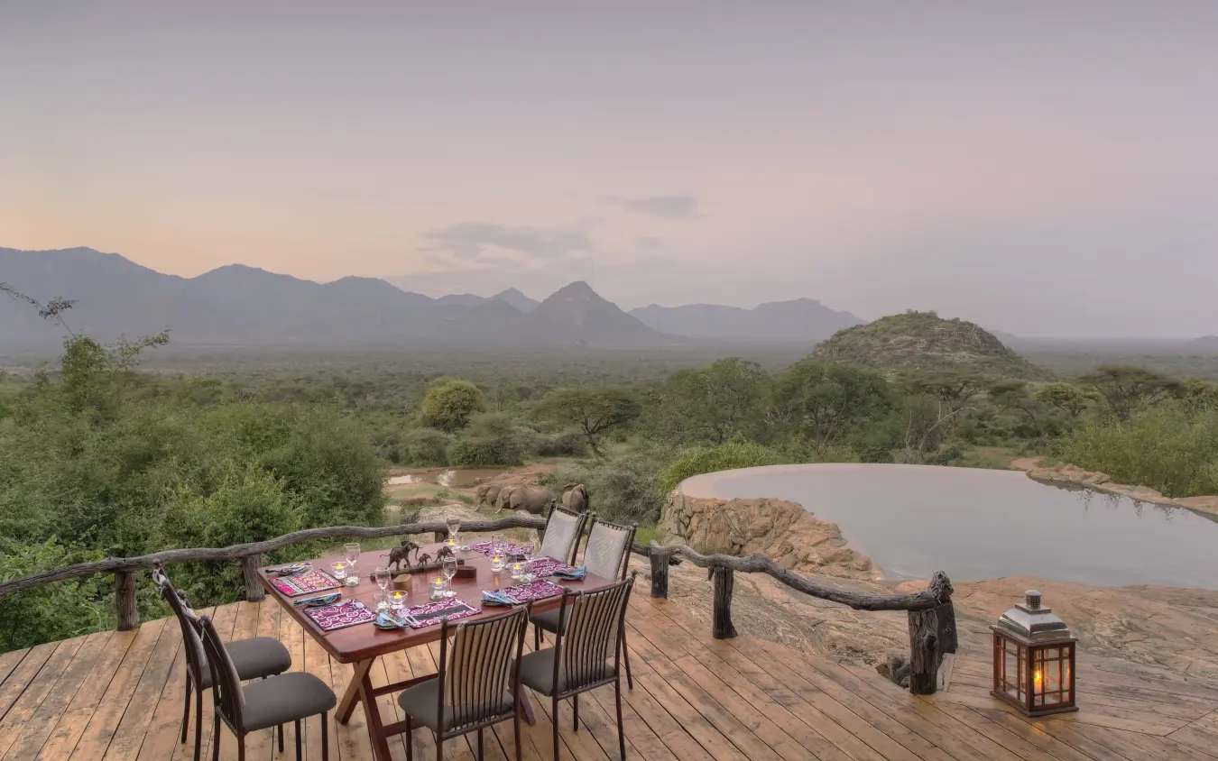 Dining deck overlooking waterhole and distant mountains, Sarara Camp, Northern Kenya, Kenya