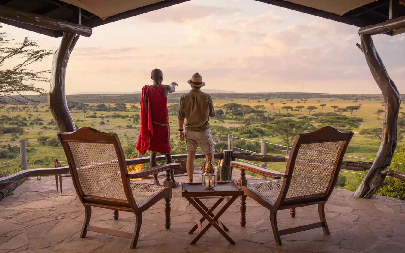 Guests viewing expansive savanna landscape from wooden deck, Eagle View Camp, Maasai Mara, Kenya