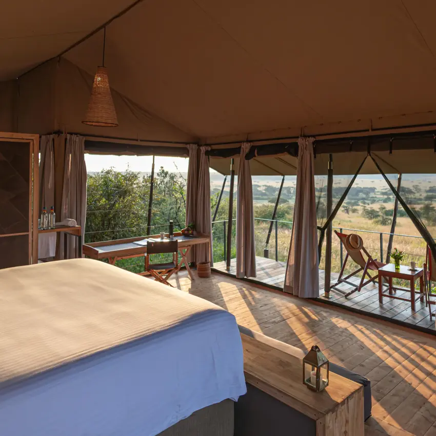 Spacious bedroom with expansive views of savanna landscape, Eagle View Camp, Maasai Mara, Kenya