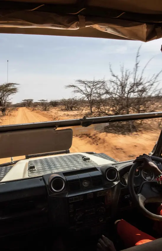 Safari vehicle interior on dusty track through arid bushland, Saruni Rhino, Northern Kenya, Kenya
