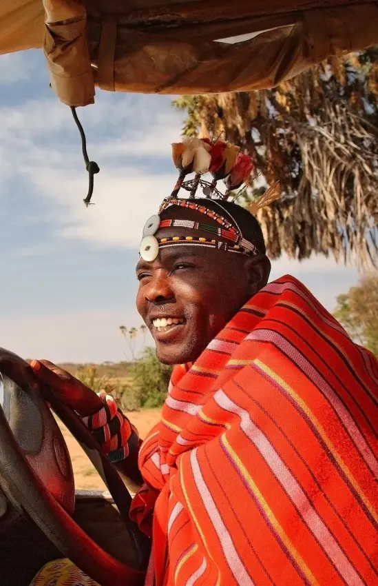 Man in traditional red garment driving open safari vehicle, Saruni Samburu, Samburu Reserve, Kenya