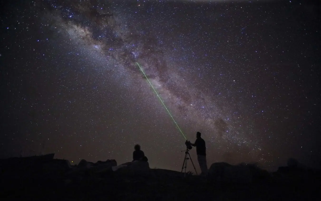Guests stargazing with telescope under Milky Way, Saruni Samburu, Samburu Reserve, Kenya