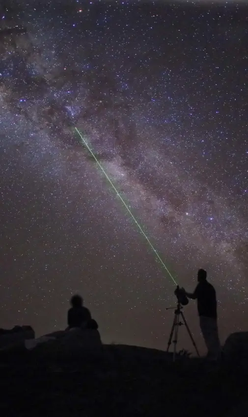 Guests stargazing with telescope under Milky Way, Saruni Samburu, Samburu Reserve, Kenya