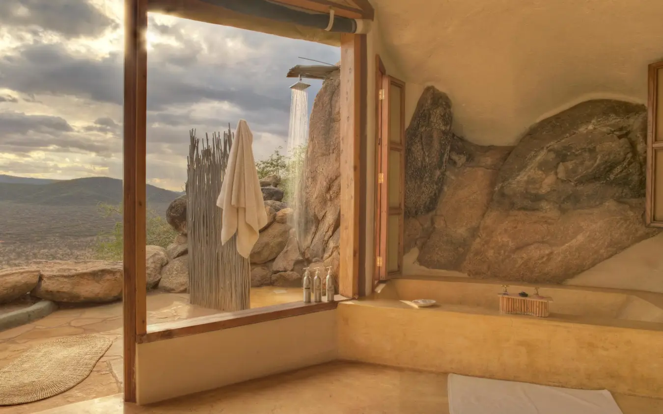 Luxury bathroom with natural stone features and valley views, Saruni Samburu, Samburu Reserve, Kenya