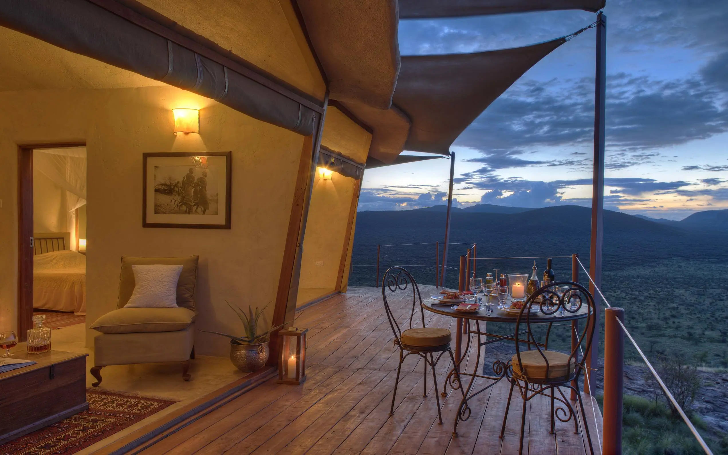 Open-air bedroom deck overlooking vast savanna at dusk, Saruni Samburu, Samburu Reserve, Kenya