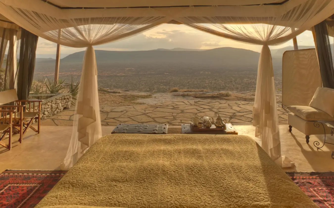 Luxury bedroom tent with draped canopy and valley views, Saruni Samburu, Samburu Reserve, Kenya