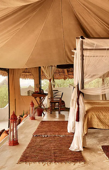 Luxury safari tent interior with canopy bed and lounge area, Sasaab, Samburu Reserve, Kenya